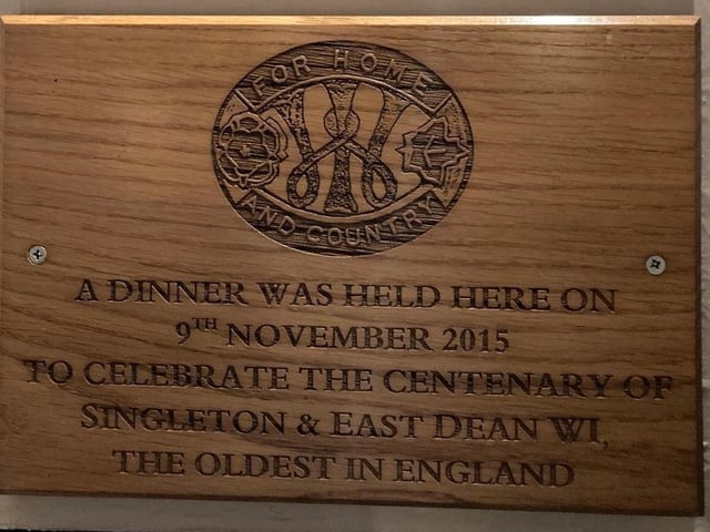 Plaque at The Fox Goes Free, in Charlton, noting a dinner was held there on November 9, 2015, to celebrate the centenary of Singleton & East Dean WI, the oldest in England