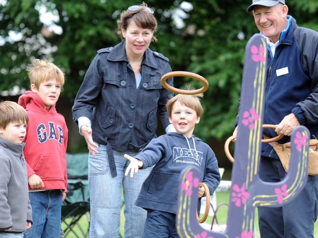 Felix Evison tries his hand at the hoopla stall and wins a prize