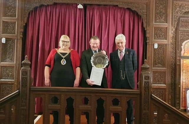 Kevin Boorman receives the award from the Mayor and Reg Wood