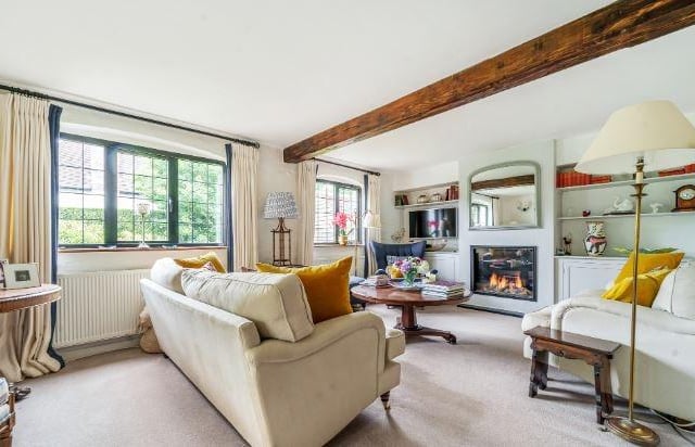 The L-shaped sitting and dining room benefits from the recent addition of a modern gas burning fireplace, as well as a traditional log burning stove.