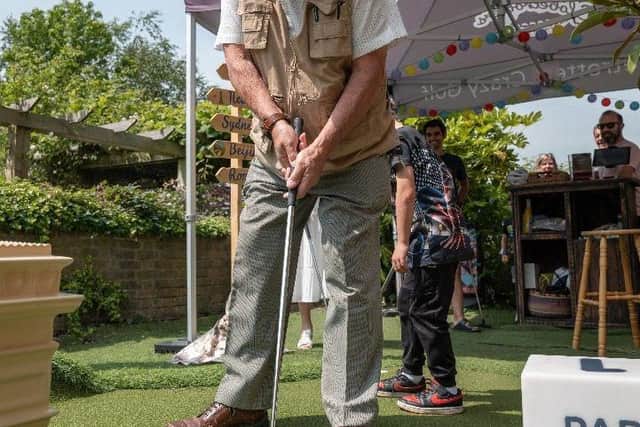 Councillor Chris Mullins, Crawley Borough Council cabinet member for leisure and wellbeing, makes his way round the course. Photo: Globetrotters Crazy Golf