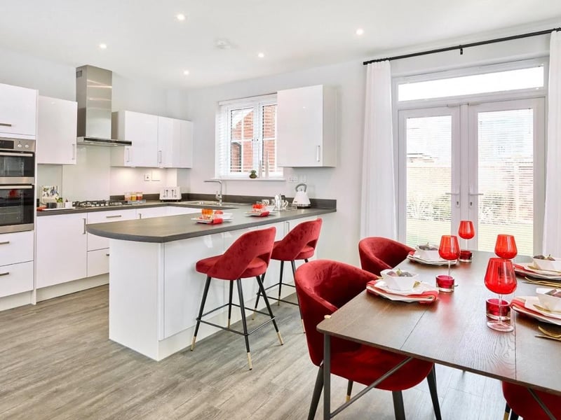 The kitchen is fitted with gloss finish Paula Rosa Manhattan units with quartz worktops and integrated appliances