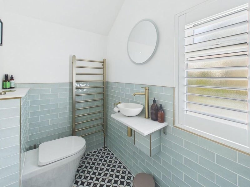 There is a walk-in shower, toilet and floating vanity basin