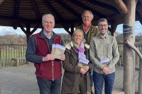 District Councillor Francis Hobbs with parish councillors Elaine Roberts Grimsey (Easebourne), Rob Harris (Heyshott) and Jim Summers ( Lodsworth) in Easebourne Park promoting the climate response booklet