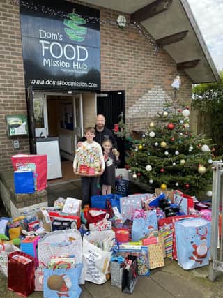 Talan delivering the presents to Don’s FOOD mission.