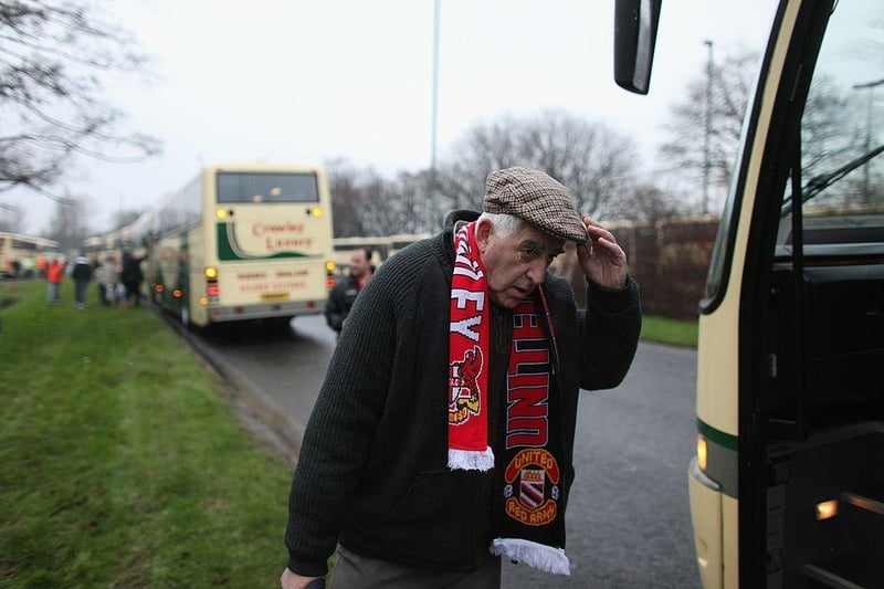 A fan of Crawley Town boards a coach to Manchester to watch Crawley take on Manchester United in the FA Cup fifth round at Old Trafford on February 19, 2011.