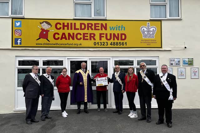 Paul Rose from the Red Cross of Constantine (fourth from the left) handing over the donation to the Children with Cancer Fund - Polegate