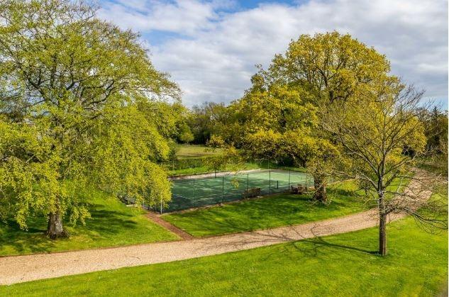 Outside, the grounds include a tennis court