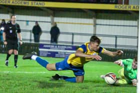 Fletcher Holman of Eastbourne Town dives for the ball with the Egham goalkeeper in Town's FA Vase loss | Picture: Josh Claxton