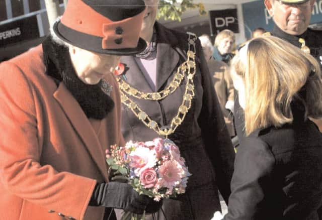 The Queen receives flowers from a young well wisher