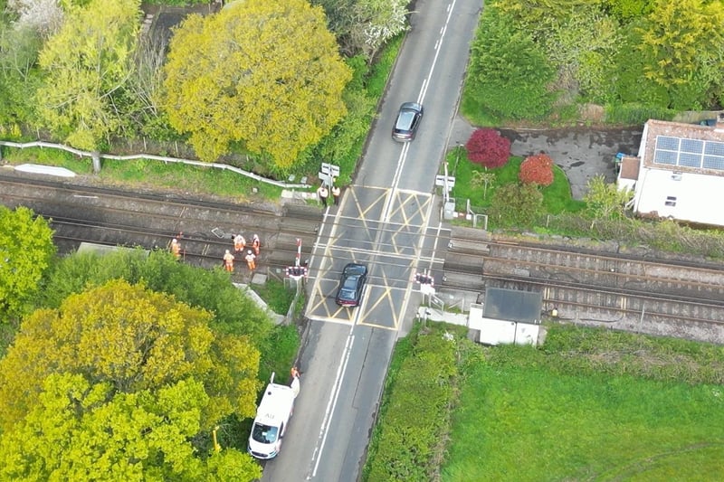 Staff at the level crossing in Adversane Lane, Billingshurst, working to repair the damaged line. Still from drone footage.