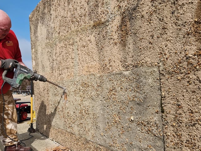 Pete Coe, one of the project leaders, and fellow former Royal Engineer Graham Cosham worked together to open the southern embrasure at the Ferring pillbox
