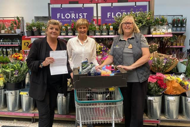 Alison Whitburn, community champion at Morrisons in Littlehampton, and her manager Sharon Brockwell present Sarah Dakin, fundraising and communications manager at Stonepillow, with a box of toiletries and a donation of £184