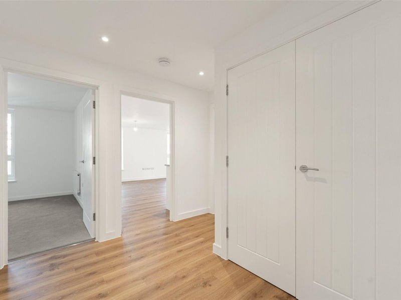 One two-bedroom apartment with balcony on the second floor is priced at £295,000. It has a light and spacious hallway and open-plan living / dining / kitchen area.