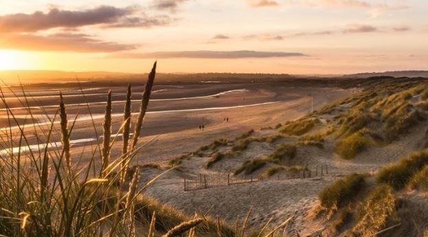 Camber Sands - This stunning beach is situated near Rye in East Sussex and boasts miles of golden sand dunes and shallow waters. It's a popular spot for water sports such as kitesurfing and windsurfing, and there are plenty of cafes and restaurants nearby to enjoy.