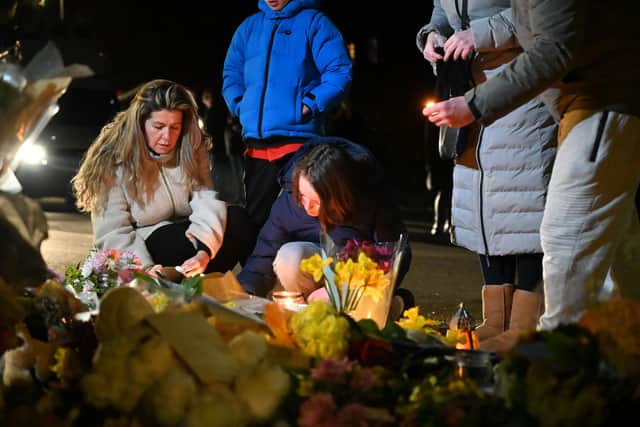 People gathered in Brighton yesterday to pay their respects after the remains of a baby were found in a nearby woods