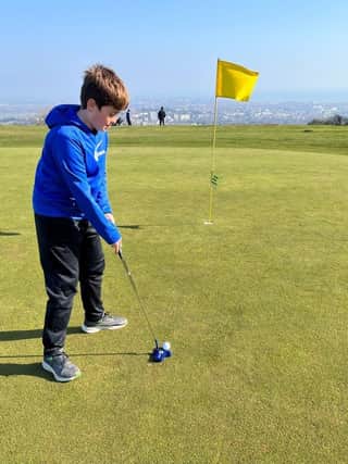 Junior player tries out Eastbourne Downs Golf Course