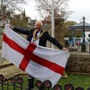 Horsham District Council chairman David Skipp raises the St George's flag in Horsham town centre