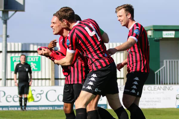 Lewes celebrate with Joe Taylor as his second-half double secures a 4-1 win at Bognor - keeping the Rooks' play-off chances alive | Picture: James Boyes