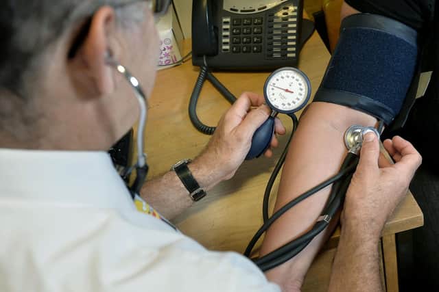 File photo dated 10/09/14 of a GP checking a patient's blood pressure. The current NHS system for seeking care "is not fit for purpose", according to a review, which recommends new neighbourhood teams to improve access for patients. Issue date: Thursday May 26, 2022.