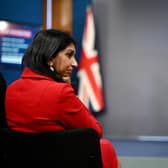 Home Secretary Suella Braverman listens as Prime Minister Rishi Sunak speaks during a press conference following the launch of new legislation on migrant channel crossings (Photo by Leon Neal/Getty Images)