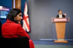 Home Secretary Suella Braverman listens as Prime Minister Rishi Sunak speaks during a press conference following the launch of new legislation on migrant channel crossings (Photo by Leon Neal/Getty Images)