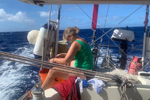Kate on board their sailing boat en route to New Zealand