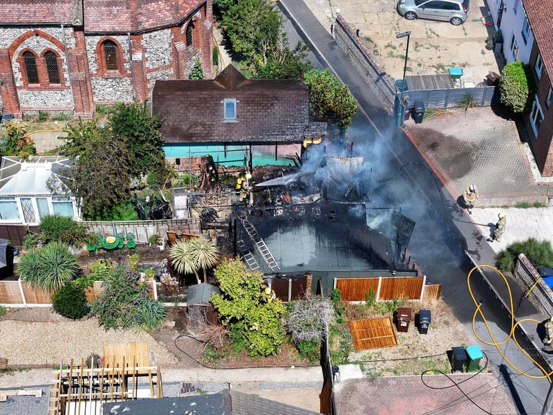 Firefighters tackle a blaze that destroyed two sheds, on Beaconsfield Road