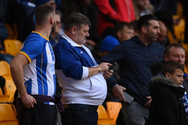 WOLVERHAMPTON, ENGLAND - NOVEMBER 05: A fan uses their phone prior to the Premier League match between Wolverhampton Wanderers and Brighton & Hove Albion at Molineux on November 05, 2022 in Wolverhampton, England. (Photo by Mike Hewitt/Getty Images)