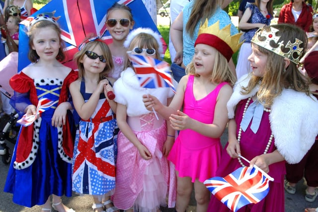 Children waving their Union flags as they enjoy the parade