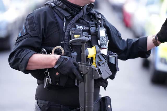 Armed police swarmed a road near Worthing seafront and detained at least one person.