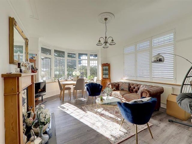 The dining room has a feature wrought iron fireplace with coal effect gas fire