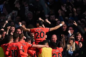 Brighton's Paraguayan striker Julio Enciso celebrates with the fans after scoring a stunning goal against Chelsea  (Photo by BEN STANSALL/AFP via Getty Images)
