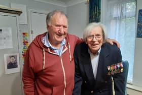 Jack Biggs, wearing his medals, with his cousin Geoff Grayson and, left, a picture of Jack when he was in the RAF