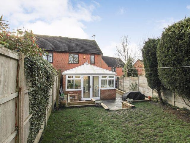 This final image of the property shows the back lawn and how the trees and fencing give the rear garden plenty of privacy.
