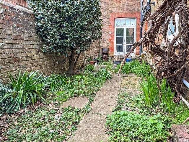 There are front, side and private rear gardens with a grapevine and powered shed