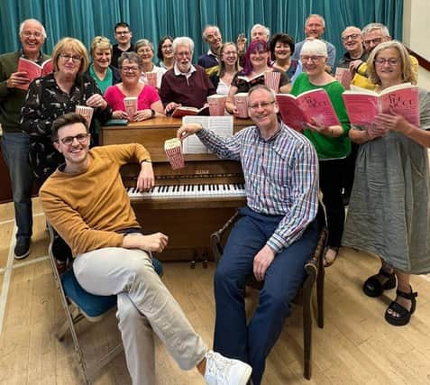Singers share some popcorn with Music Director Sebastian Charlesworth and Pianist Howard Beach (front from left) during a rehearsal for Songs On Film concert