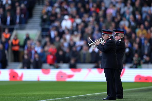 The British Armed Forces participate in a minute silence in honour of Armistice Day prior to the Premier League match