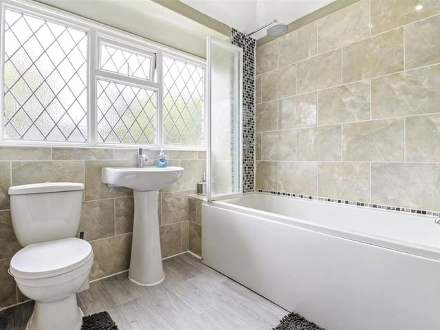 The family bathroom is fitted with a contemporary suite