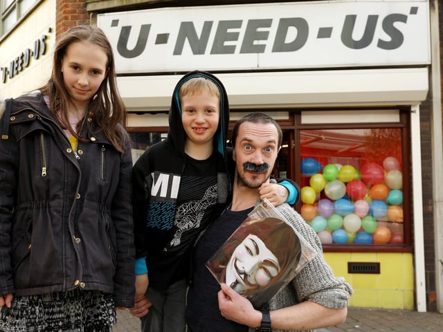 Matthias Hepworth and his children, Ben, 8, and Sophia, 11, outside U-Need-Us on its last day of trading. Picture: Chris Moorhouse (300319-20)