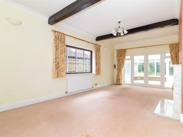 The lounge is a large double-aspect room with feature marble fireplace