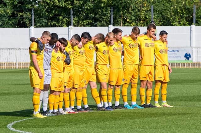 Burgess Hill Town line up for a minute's silence for The Queen at Met Police | Picture: Chris Neal