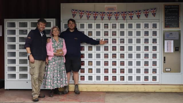 Nic , Kathy & Archie Evans with their new vending machine on Lockgate Road