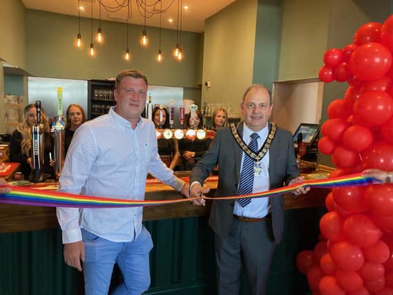 Joint owner Harry Dumville and the mayor Francis Opler cutting the ribbon