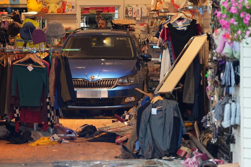A car has collided with a charity shop in Chichester.