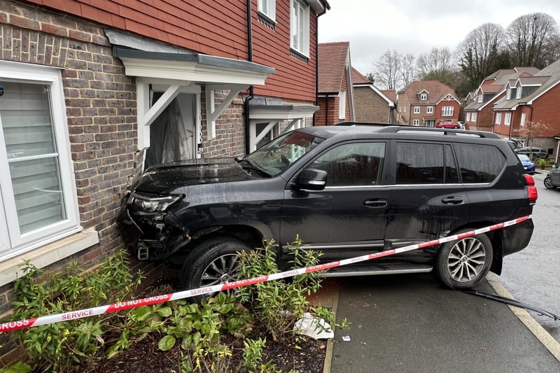The emergency services were called to Clockfield in Turners Hill after a car collided with a house on Christmas Day.