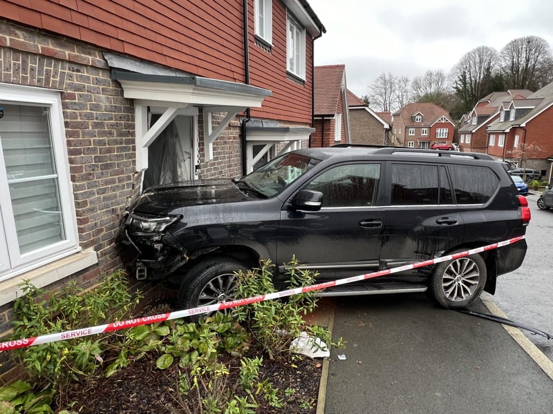 The emergency services were called to Clockfield in Turners Hill after a car collided with a house on Christmas Day.