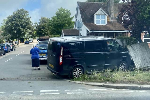 A photo taken in Uplands Avenue at 11.30am shows a van on a grass verge, alongside a damaged wooden fence outside a house. (Photo contributed)