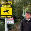 Cllr Connor Winter by one of the new signs