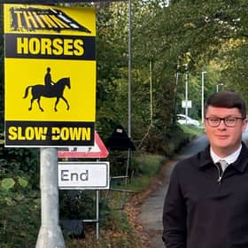 Cllr Connor Winter by one of the new signs